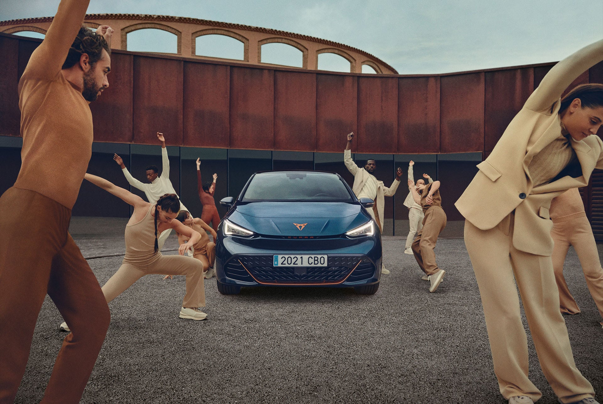 People posing near a CUPRA Born Aurora Blue colour in a parking