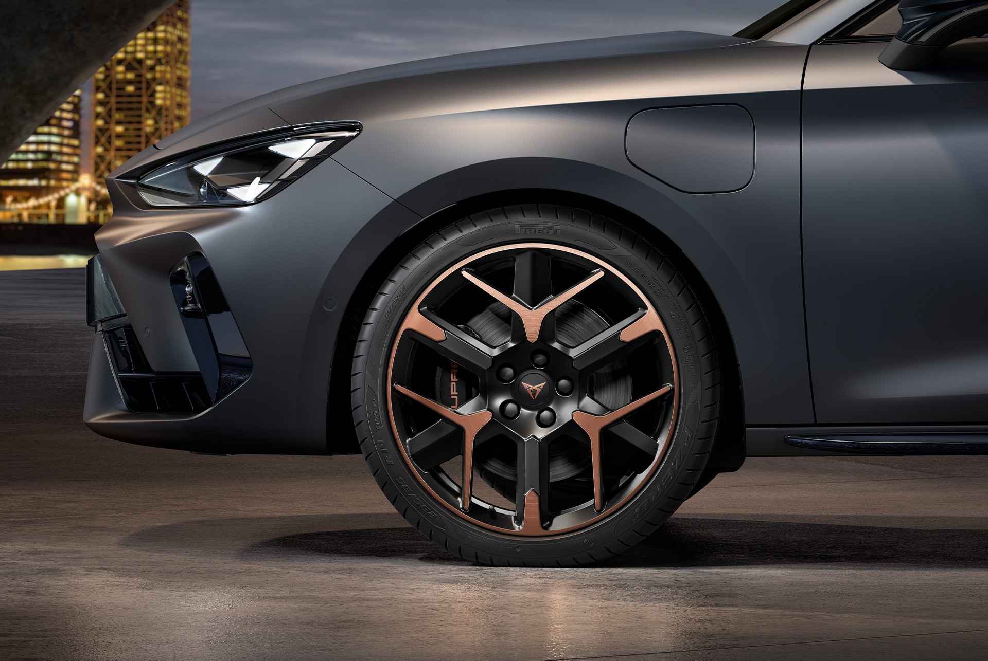 front side view of left forged alloy wheel in copper and black for the new cupra leon spotstourer 2025, tyres, signature headlights and grey body