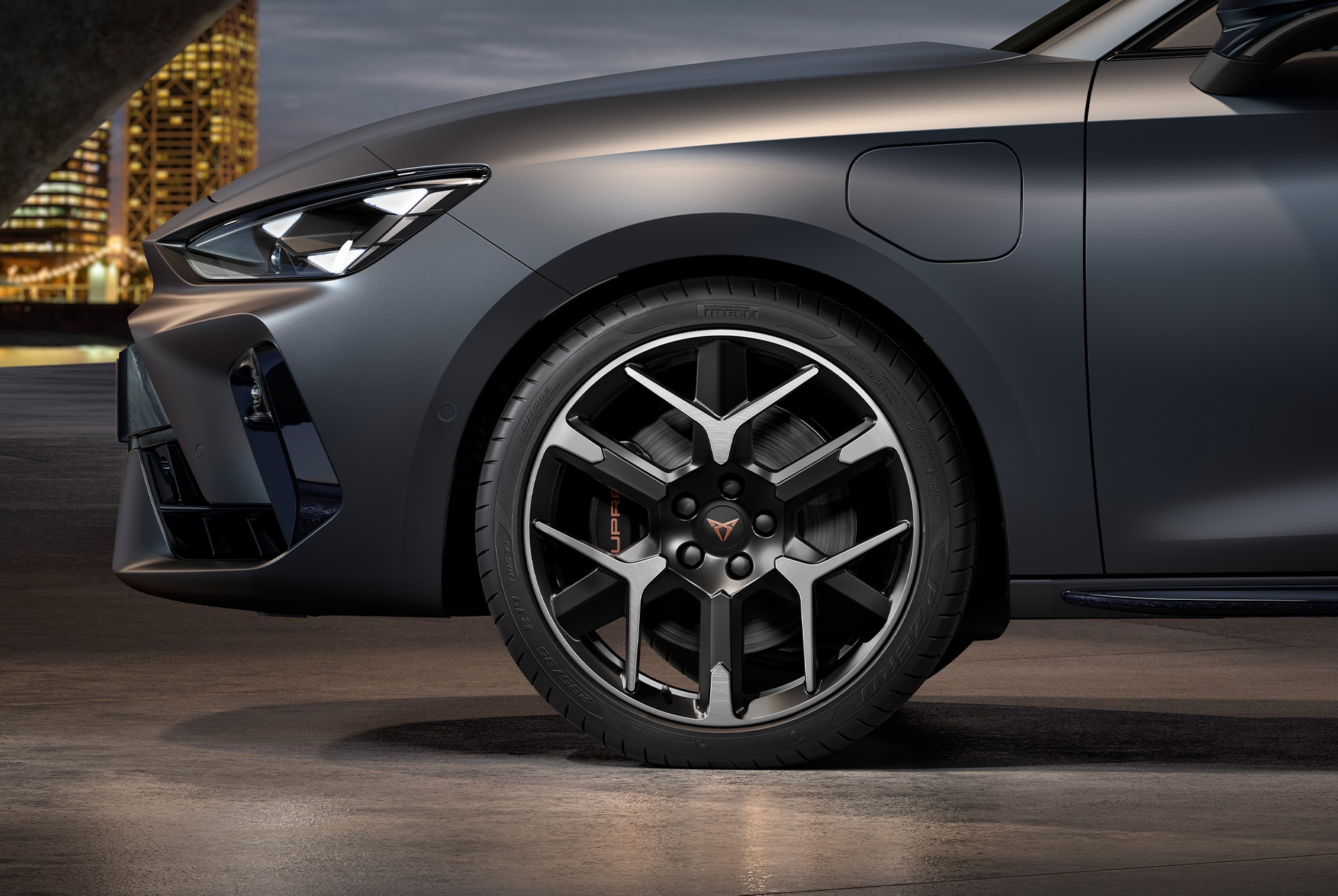 front side view of left forged wheel in silver nd black for the new cupra leon spotstourer 2025, tyres, signature headlights and grey body