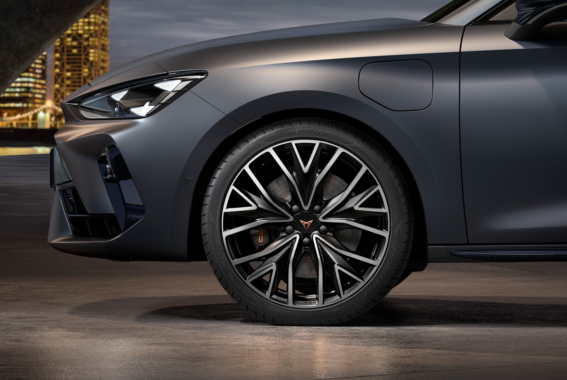 front side view of left mistral machined alloy wheels in silver and black for the new cupra leon sportstourer 2025, tyres, signature headlights and grey body