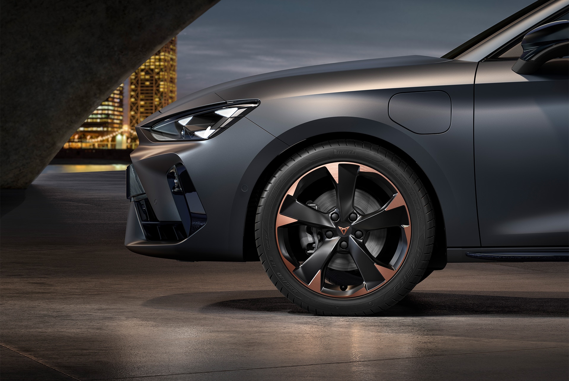 front side view of left mistral garbi copper machined alloy wheels for the new Cupra Leon 2025, tyres, signature headlights and matt grey body.