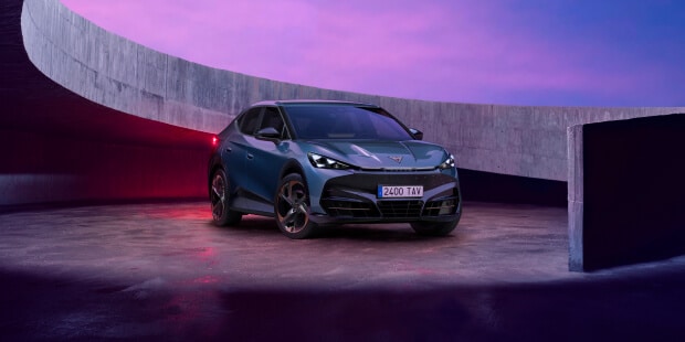 Cost of running an electric car vs petrol in the Ireland — CUPRA Tavascan VZ in Tavascan Blue, 3/4 front view in a futuristic urban setting.