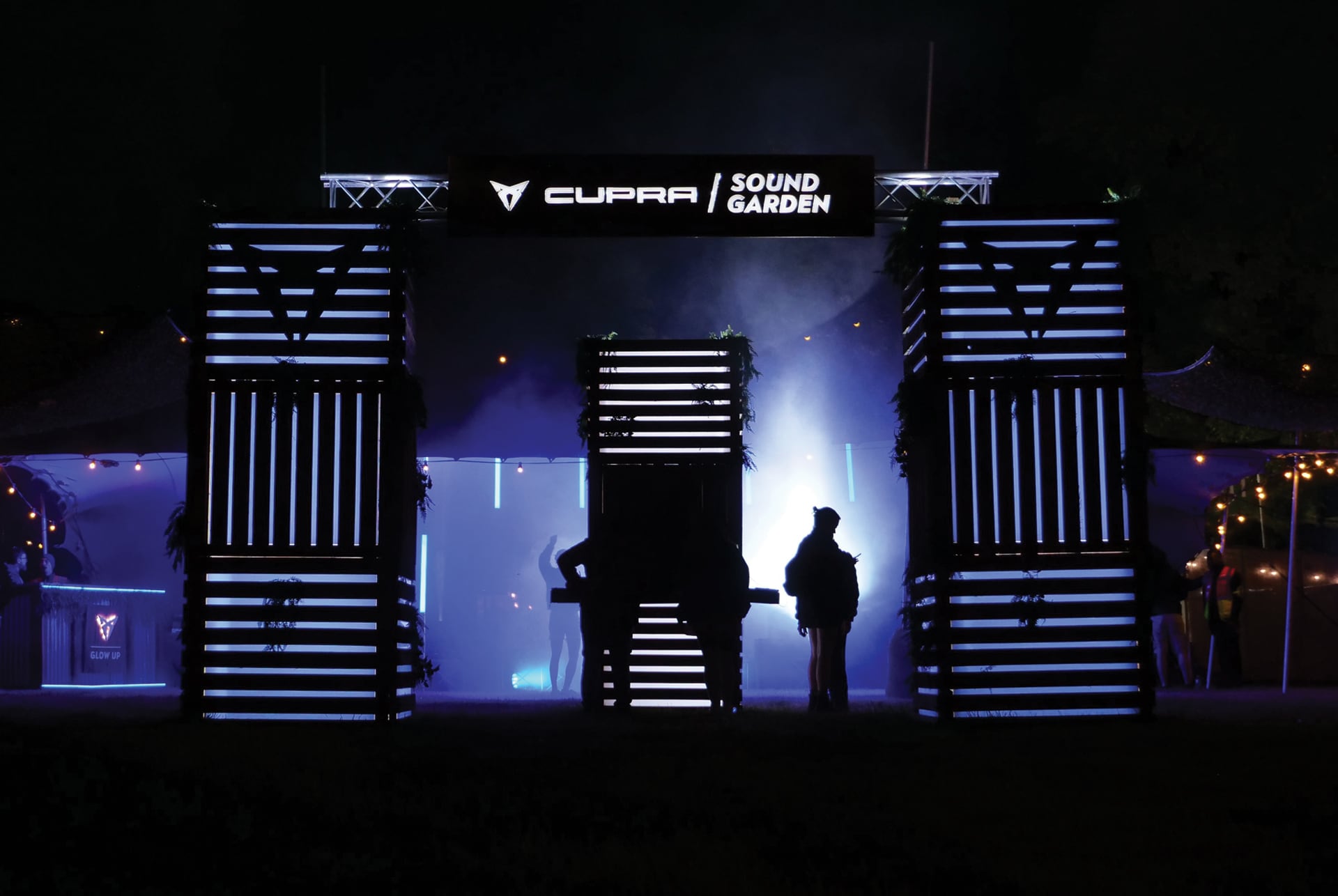CUPRA Sound Garden at night during the Beyond the Pale festival, featuring vibrant lights and a lively atmosphere.