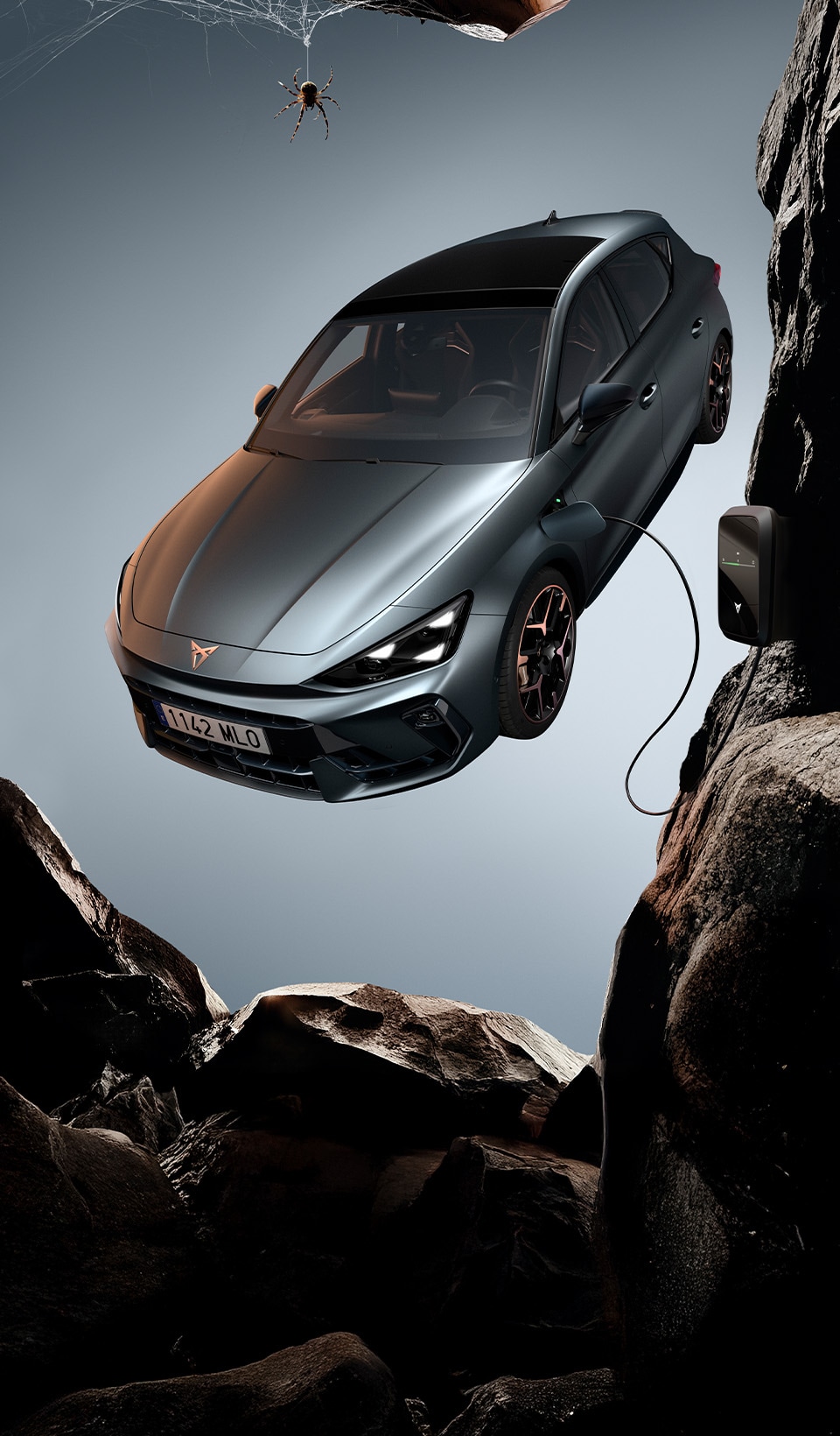 A CUPRA Leon hatchback seen from an elevated angle with its headlights on, next to a person covered in dark, flowing fabric that drapes onto the ground. A CUPRA Leon hatchback seen from an elevated angle with its headlights on, next to a person covered in dark, flowing fabric that drapes onto the ground.